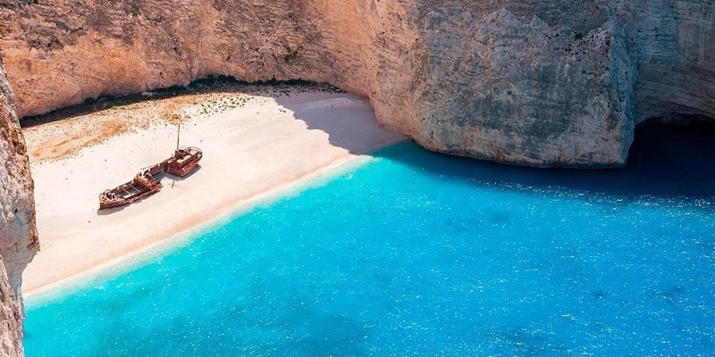 Navagio Bay in Zakynthos with cliffs and turquoise water